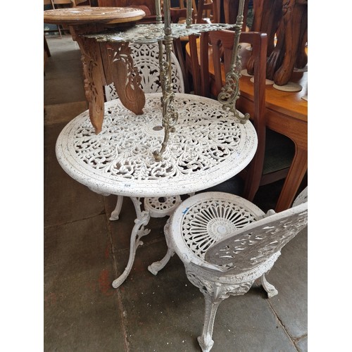 926 - A cast metal garden table and two chairs.