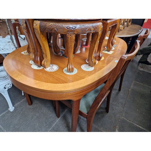 928 - A Nathan teak extending dining table and four chairs.