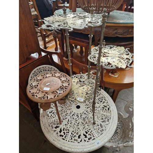 925 - A brass three tier plant stand together with an Eastern carved wood table.