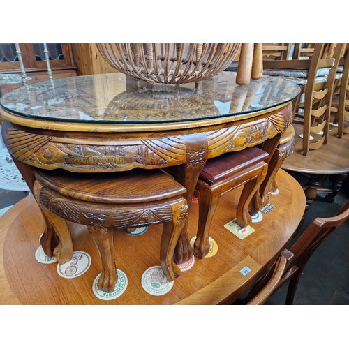 927 - A Chinese carved wood table and stools.