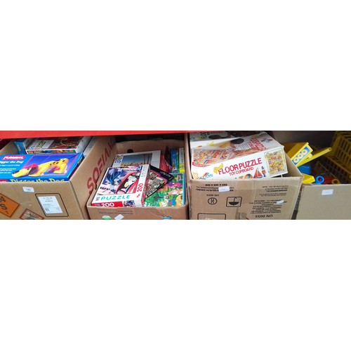 140 - 4 boxes of toys and games to include jigsaws, Floor puzzles, Playskool Digger the Dog, plastic kitch... 