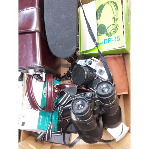 129 - A box of cameras including Zenit, Olympia, binoculars, Acer tablet, headphones, Bolex cine camera