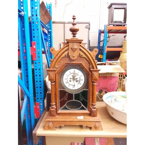 134 - A Gothic style clock with wood frame, key and pendulum - as found