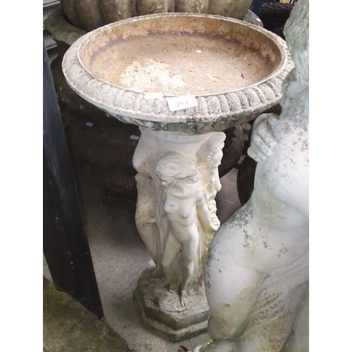 243 - A bird bath on a plinth decorated with figures