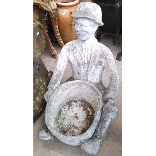 252 - A concrete planter with sitting gent holding planter