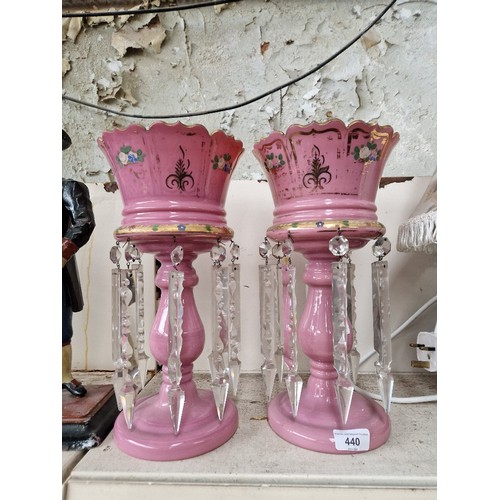 A pair of Victorian pink drop lustre vases.