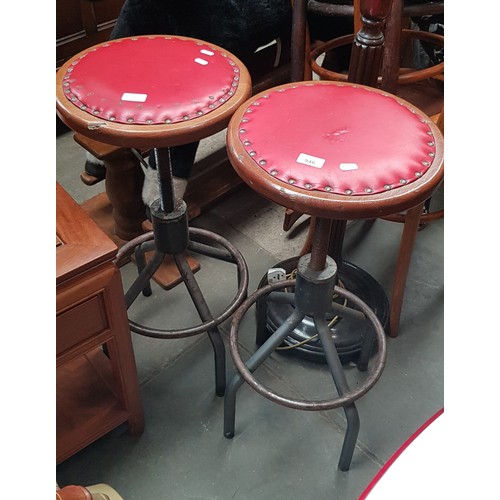 946 - A pair of industrial style bar stools.