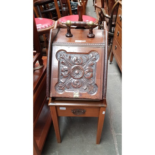 944 - A Victorian coal scuttle and a piano stool.