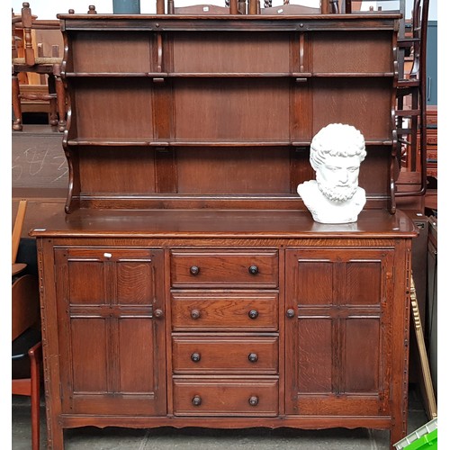 968 - An Ercol oak dresser with plate rack back.