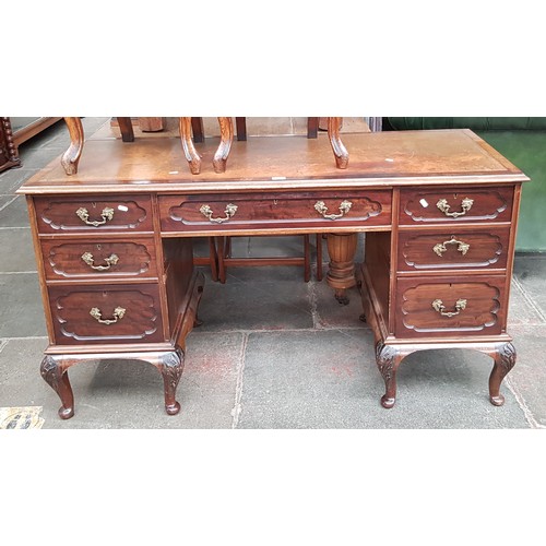 978 - An Edwardian mahogany desk with tooled leather writing surface, the locks marked 'RC&S' with a crown... 