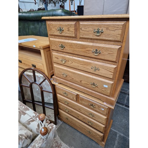 991 - A pair of golden oak chests of drawers together with a mahogany framed mirror.