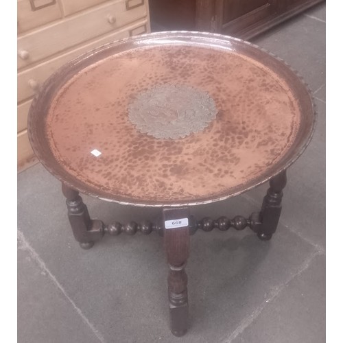 899 - An Arts & Crafts oak and copper top folding table by Hugh Wallis.