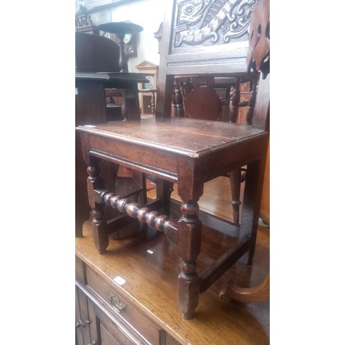 902 - An 18th century carved oak chair with dragon to the back.