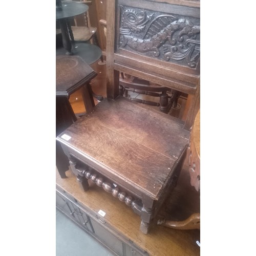 902 - An 18th century carved oak chair with dragon to the back.