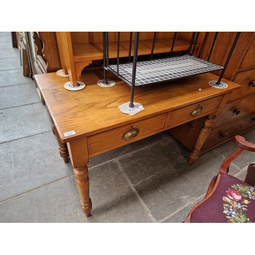 998 - An Edwardian golden oak two drawer side table.