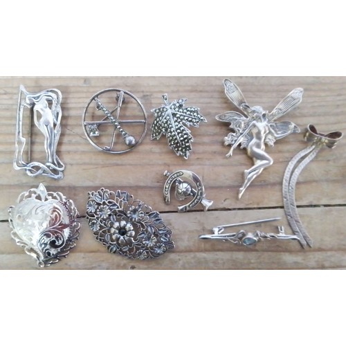 349 - A collection of nine silver brooches.