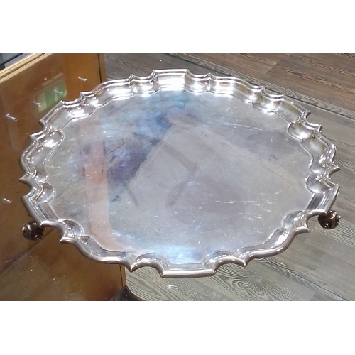 403 - A late Victorian/Edwardian large silver salver, scalloped edge, stood on three scroll feet, Goldsmit... 