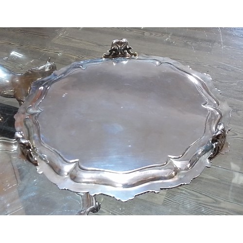 405 - A Victorian silver salver, moulded and scalloped edge, engraved, stood on three scroll feet, Edward ... 