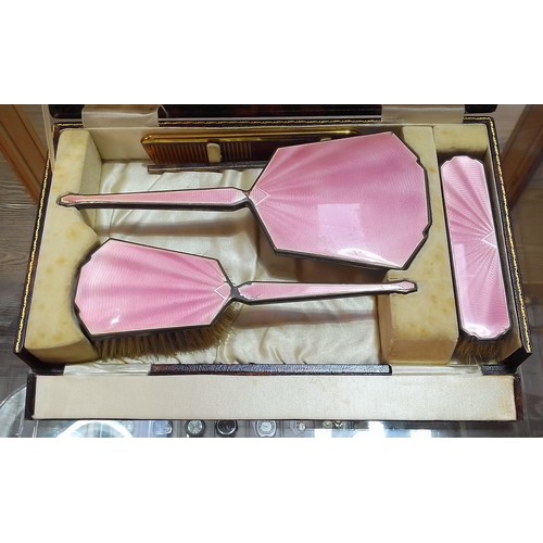 449 - An early 20th century cased hallmarked silver and pink enamel dressing table set.