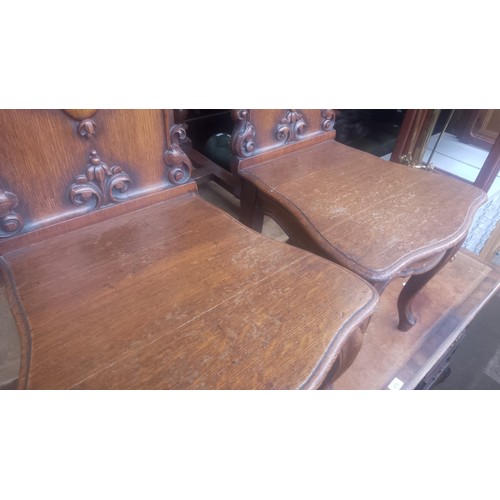 979 - A pair of 19th century oak hall chairs with cabriole legs.