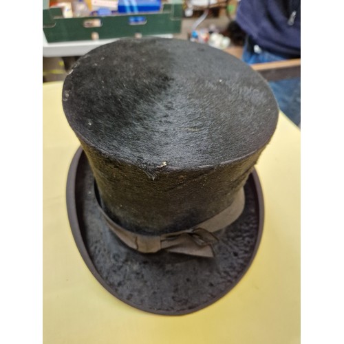 466 - A collection of vintage hats, including a top hat, police hat etc.