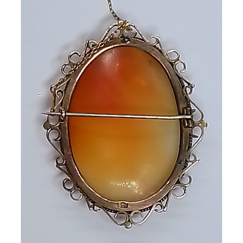 489 - A carved shell cameo brooch, 46mm x 58mm, marked '9ct', gross weight 19.3g.