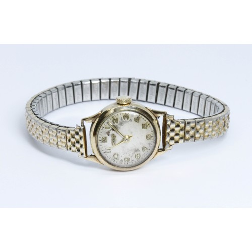 492 - A ladies 9ct gold Tissot wristwatch, gold plated flexi strap.