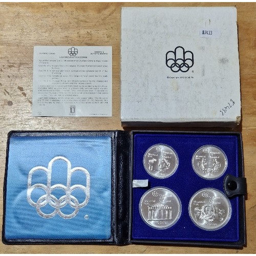 560 - A silver proof four coin set, Canada 1976 Olympics, with certificate in case.