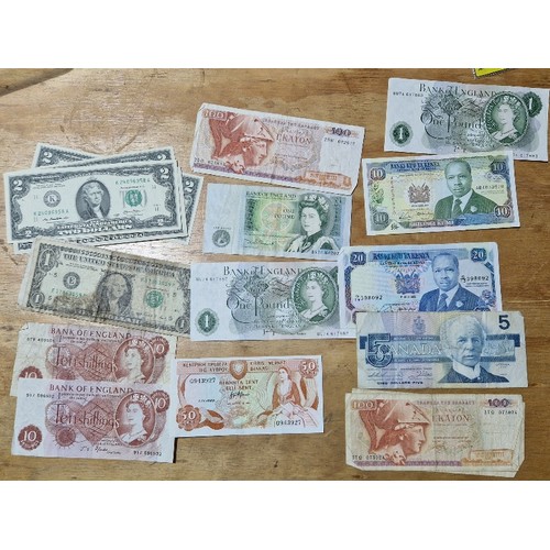 606 - A group of assorted world banknotes to include us 2 dollars etc.