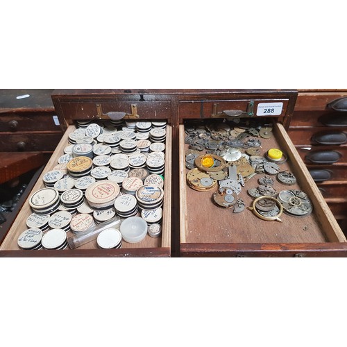 288 - A cabinet of assorted watch spares.