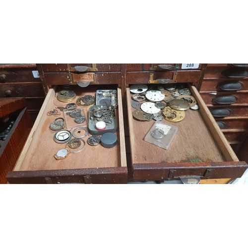 288 - A cabinet of assorted watch spares.