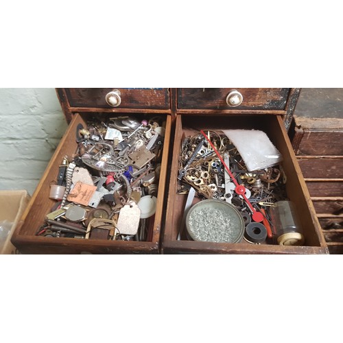 286 - A cabinet of assorted horology spares and tools.