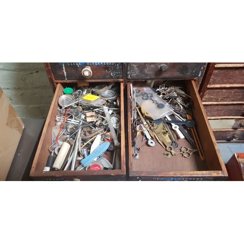 286 - A cabinet of assorted horology spares and tools.