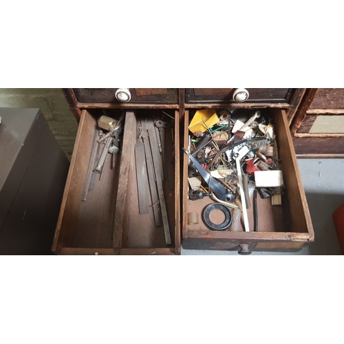 286 - A cabinet of assorted horology spares and tools.