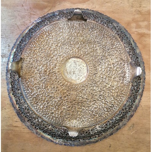 420 - An early 20th century North African/Middle Eastern white metal salver, profusely decorated with flow... 