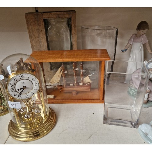 577 - Three glass vases, ship in a case and a revolving penedulum clock