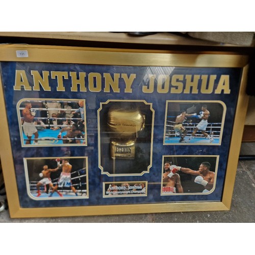 131 - An Anthony Joshua signed glove and light up picture display.