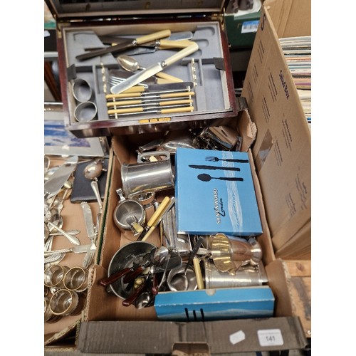 141 - A box of assorted silver plated and metal ware and a mahogany canteen and contents.