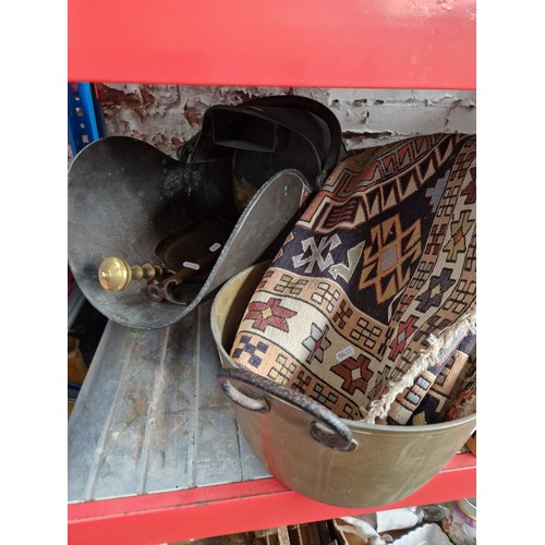 154 - A copper coal scuttle, brass shovel and poker stand, brass jam pan and small rug