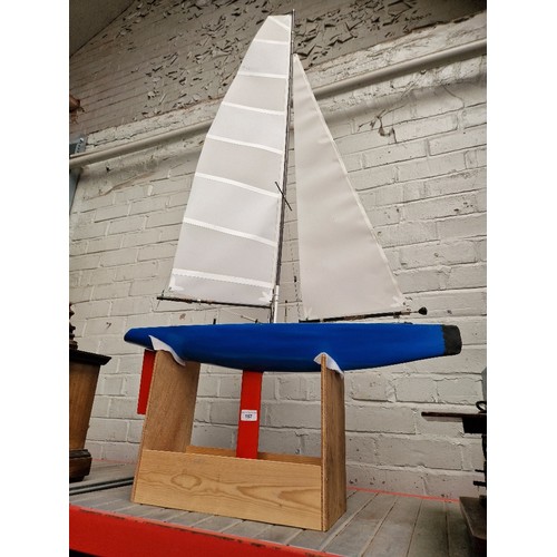 157 - A model pond yacht on stand.