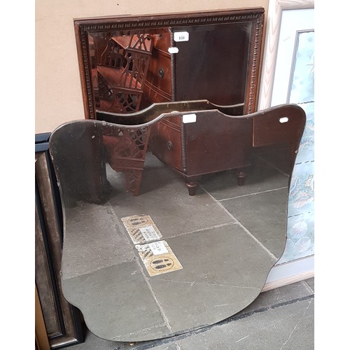 830 - An oak framed mirror and a shield shaped mirror.