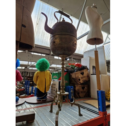 237 - A large Eastern brass kettle on stand.