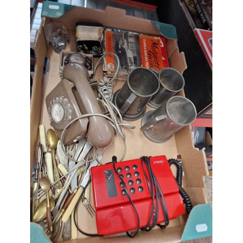 245 - A box of assorted collectables to include pewter tankards, vintage telephones, various Boys Own maga... 