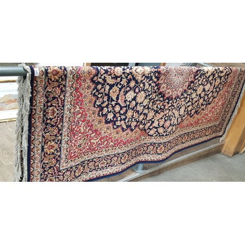 878 - An Eastern Keshan style carpet, blue ground with floral design, 240cm x 160cm (approx).