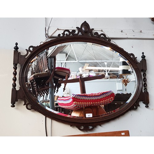 897 - A 1920s oak framed mirror.