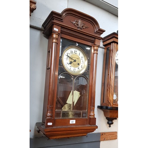 891 - A German wall clock with pendulum and key.