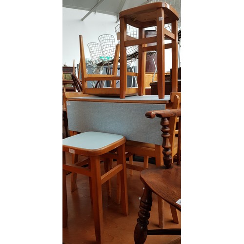 917 - A mid 20th century melamine top table with three chairs and two stools.