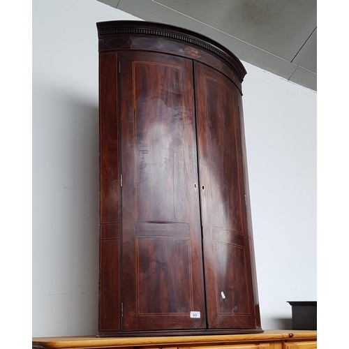 925 - A George III inlaid mahogany corner cabinet.