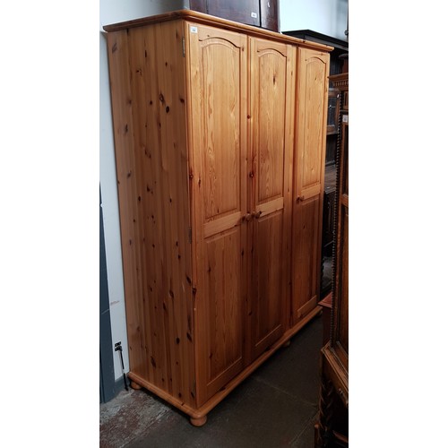 926 - A pine triple wardrobe.