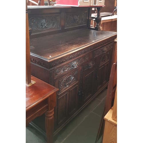 931 - A late Victorian carved oak sideboard with Green Man details.